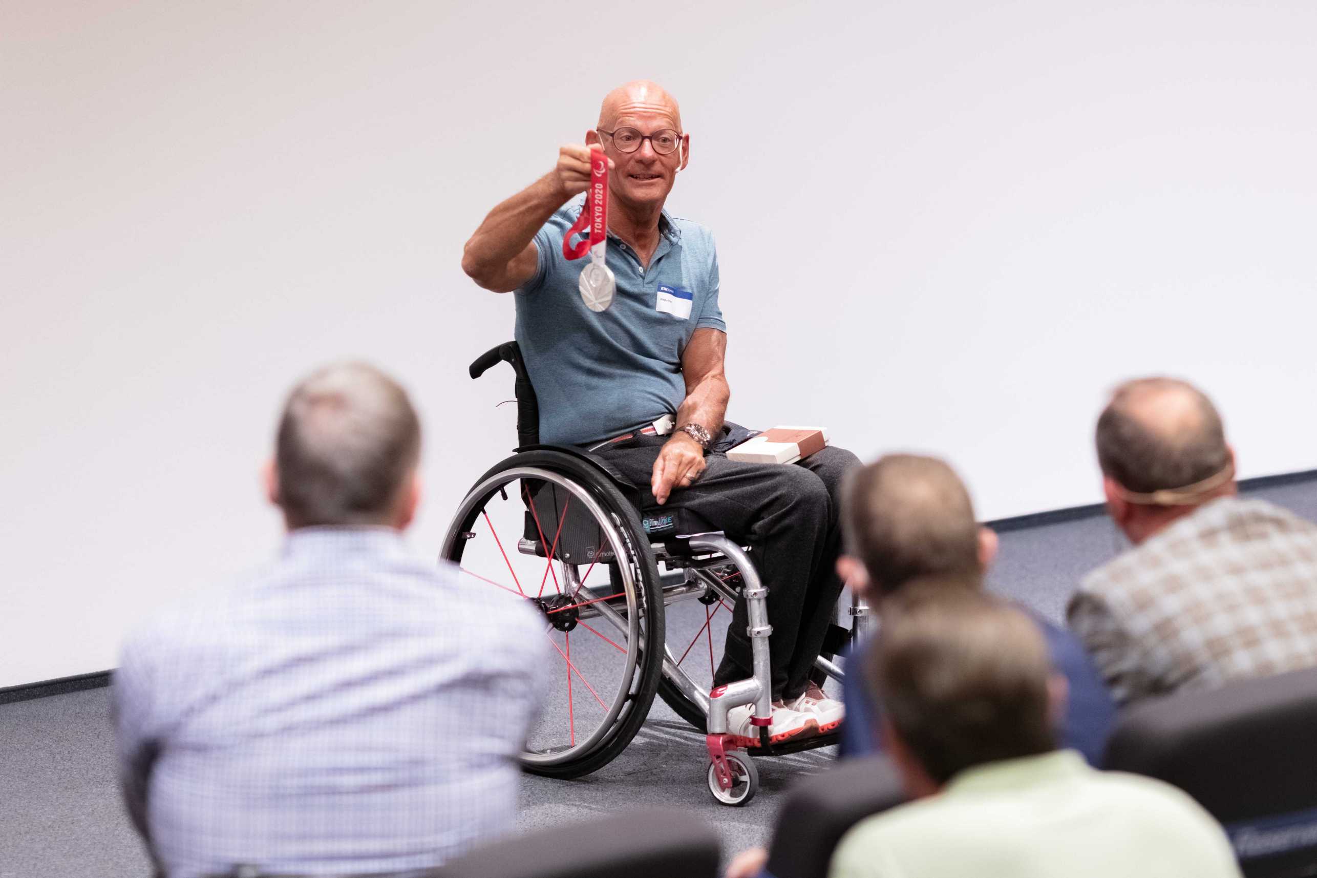 Paralympic Gold Medallist and World Champion Heinz Frei shows Olympic medal to the public