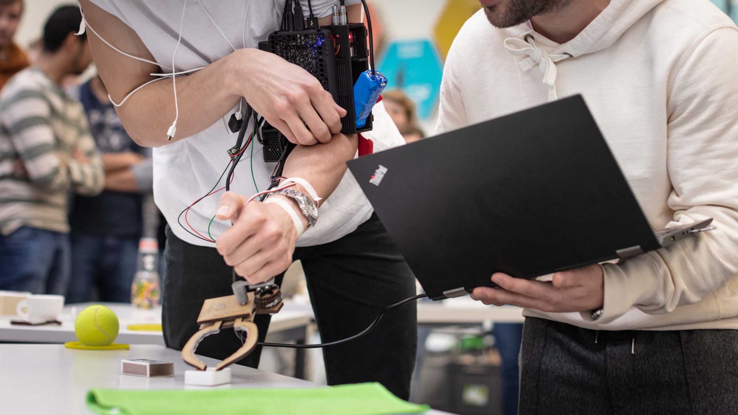 Enlarged view: Two students testing an arm exoskeleton.