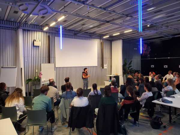 Workshop with Speaker in Front of a Screen
