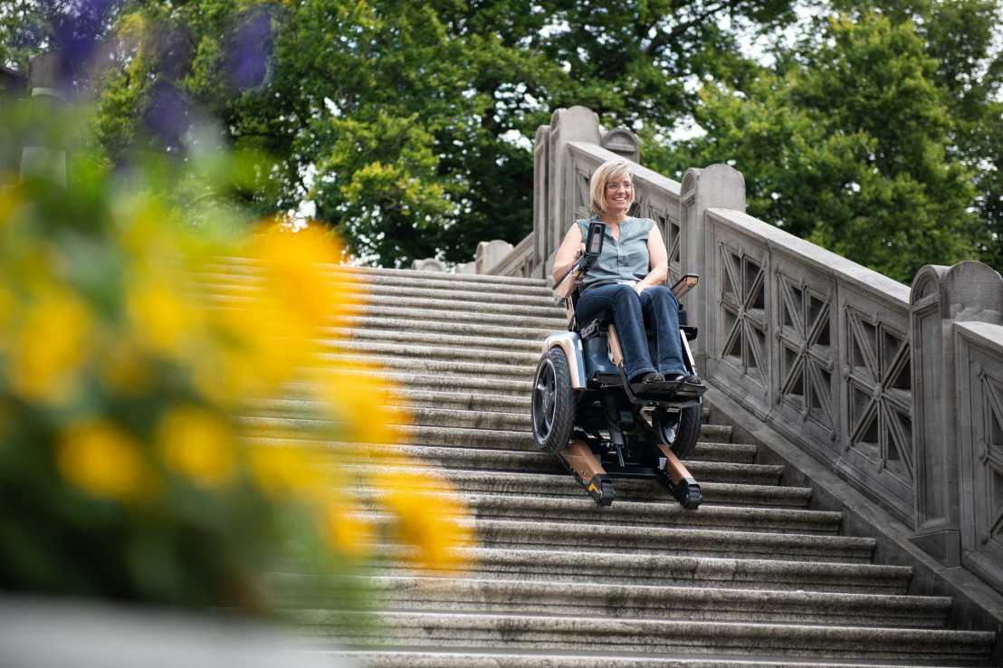 Enlarged view: Woman descending stairs on scewo stairs climbing wheelchair