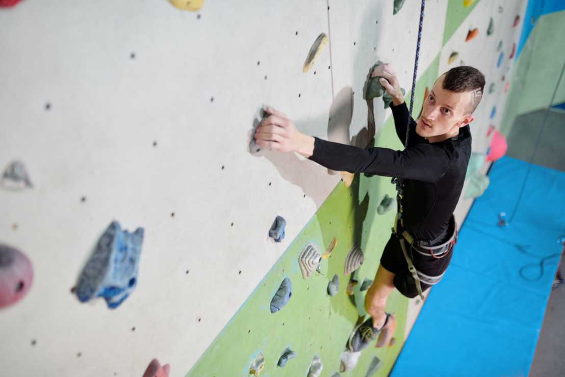 Enlarged view: Person climbs up the wall in climbing center