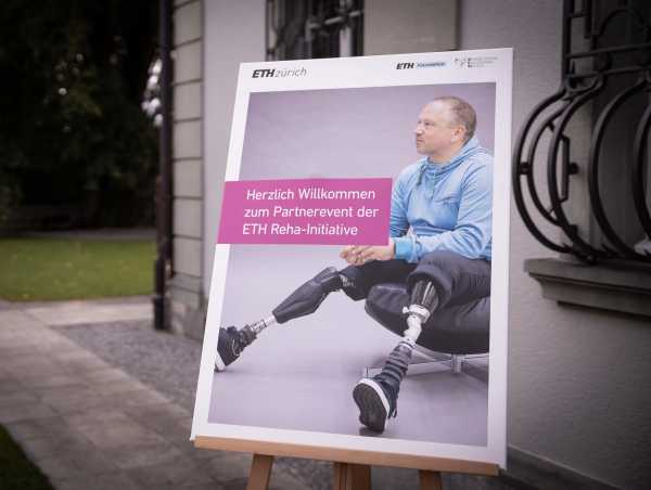 Enlarged view: Welcome Poster in front of Villa Hatt shows person with two prosthetic legs